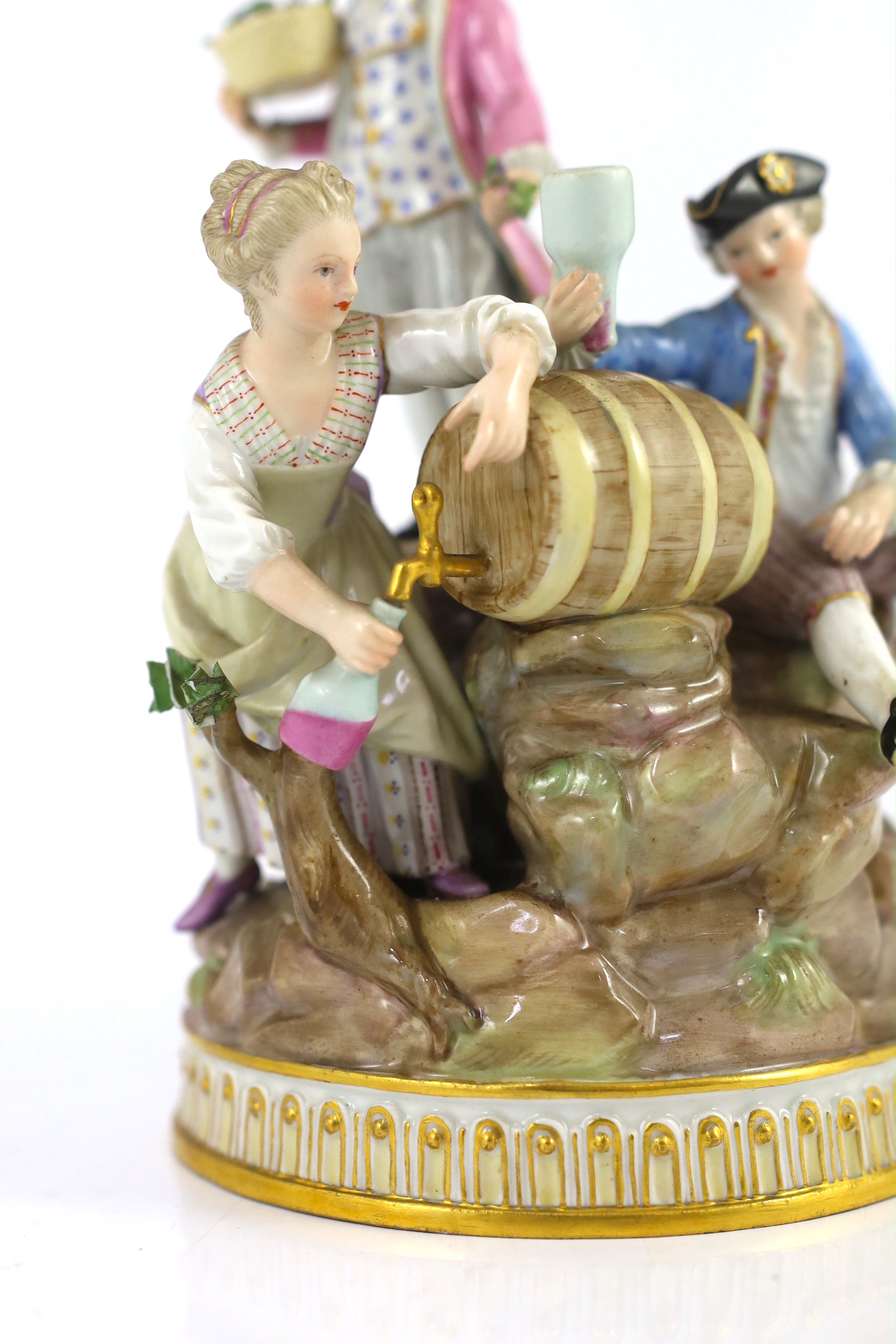 A Meissen group of grape pickers with barrels of wine, 19th century, chips to hats